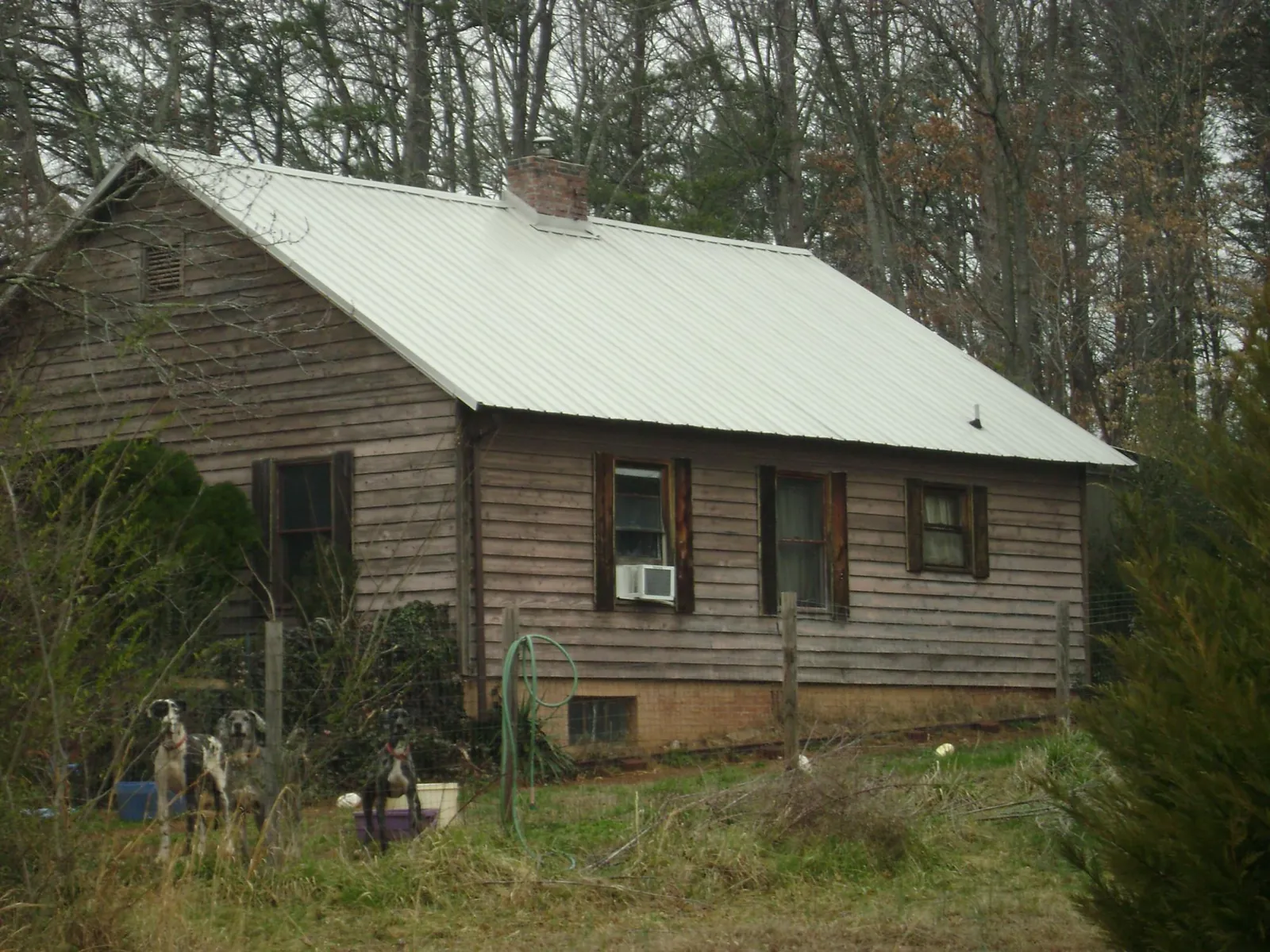 White metal roof on an old wood sided farmhouse, from a Metal Roof Installation job in Somers